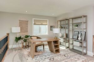 Bright modern home office designed by Alderstone Homes featuring natural light, warm wood tones, and minimalist styling.