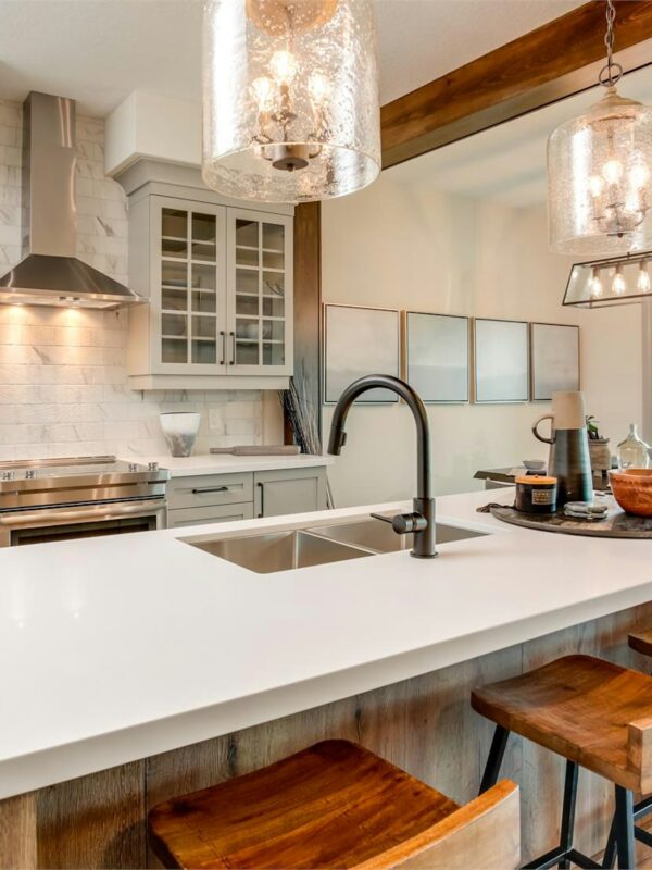 Modern custom kitchen built by Alderstone Homes in Simcoe County featuring a bright open-concept design, wood beams, quartz island, and timeless craftsmanship