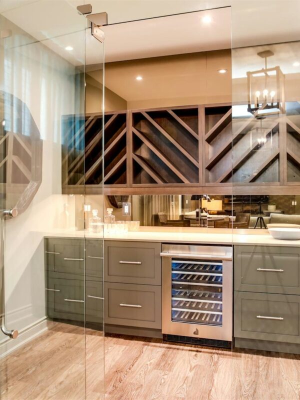 Custom Alderstone Homes interior bar with natural wood cabinetry, stone countertop, and warm ambient lighting showcasing craftsmanship and modern design in Ontario.